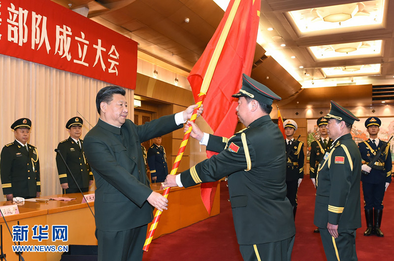 2015年12月31日，中國人民解放軍陸軍領導機構、中國人民解放軍火箭軍、中國人民解放軍戰略支援部隊成立大會在北京八一大樓隆重舉行。習近平向陸軍、火箭軍、戰略支援部隊授予軍旗並致訓詞。這是習近平將軍旗鄭重授予陸軍司令員李作成、政治委員劉雷。記者 李剛 攝